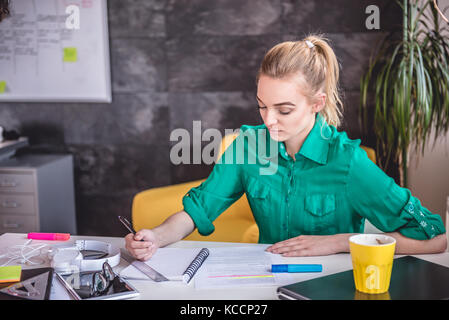 Young business woman doing paperwork in the office Stock Photo