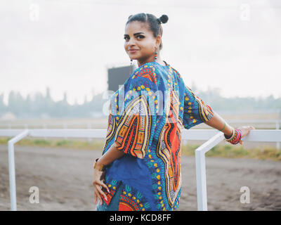 Happy beautiful afro-american woman outdoor. Young mixed race carefree girl wearing colorful clothing enjoys the day. Black Lady posing at summer as model Stock Photo