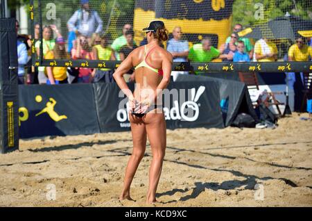 Providing behind-the-back signals to her partner prior to a serve during the quarter finals at the AVP 2017 Women’s Chicago Championships. Stock Photo