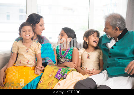 Portrait of happy Indian family having fun at home. Asian parents and children indoors lifestyle. Stock Photo