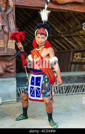 Naga tribal warrior in traditional outfit standing with spear in front of a  hut, Hornbill Festival, Stock Photo, Picture And Rights Managed Image. Pic.  PNM-20121205-SA0326 | agefotostock