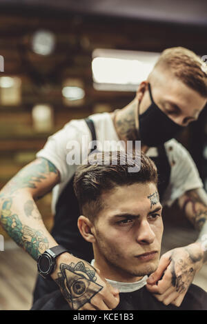 Anonymous barber preparing client Stock Photo