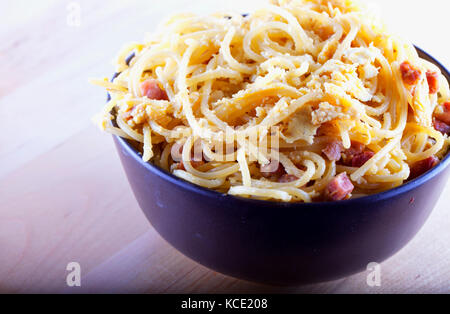 Spaghetti alla carbonara in a brown cup, horizontal image Stock Photo