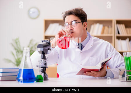 Mad crazy scientist doctor doing experiments in a laboratory Stock Photo