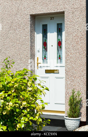 New traditional style front door with stained glass and brass door fittings Silk Mill Road, Leeds. on house with retro fitted external wall insulation Stock Photo