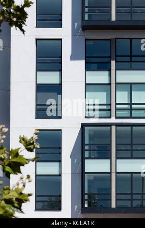 Patterns with windows on the elevationsof a modern  London housing development. Stock Photo