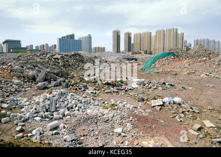 Inner city redevelopment Taiyuan city, Shanxi Province, China. Demolition debris from old hutong ghetto clearance. New high rise accommodation behind Stock Photo