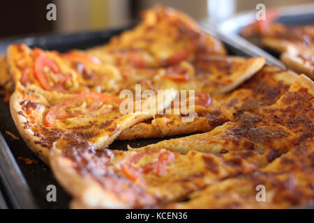 Sliced mixed pizza on the metal tray Stock Photo