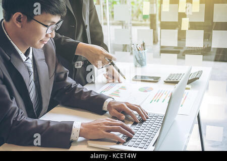 Group of business partners discussing ideas and planning work in office. Stock Photo