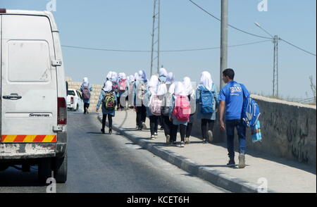 Palestinian children leave a school at the end of the school day; Bethlehem, West Bank, Palestine Stock Photo