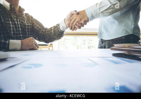 Two businessmen shaking hands during a meeting in the office, success, dealing, greeting & business partner. Stock Photo