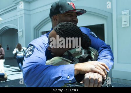 U.S Army Spc. Melissa Elliott assigned to the South Carolina Army National Guard Company A, 1-111th General Support Aviation Battalion, is welcomed home by loved ones awaiting her return home to Columbia, South Carolina, May 2, 2017 from a deployment to Kuwait. Spc. Elliott was deployed for approximately nine months in support of Operation Spartan Shield. (U.S. Army National Guard photo by Spc. Chelsea Baker) Stock Photo