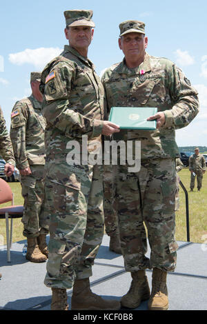 The 59th Troop Command, South Carolina Army National Guard, conducts a change of command ceremony at McEntire Joint National Guard Base in Eastover, South Carolina, June 10, 2017. Outgoing commander U.S. Army Col. Robert Carruthers relinquished command to U.S. Army Lt. Col. Timothy Wood with U.S. Army Maj. Gen. Robert E. Livingston, Jr., the adjutant general for South Carolina, officiating the ceremony. The event also recognized a change of responsibility for the highest ranking non-commissioned officer in the 59th Troop Command, where outgoing Command Sgt. Maj. Chet Welch transferred responsi Stock Photo