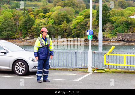 Isle of Skye, Scotland, UK. 4th October, 2017. UK Weather:  A Calmac ferryman on duty at Armadale Pier on a cold day with light winds. Credit: Skully/Alamy Live News Stock Photo