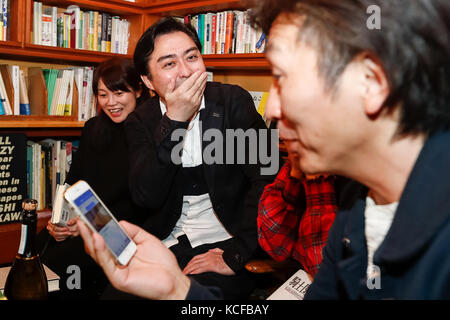 Tokyo, Japan. 5th Oct, 2017. Fans of Japanese author Haruki Murakami react after hearing the result of the Nobel Literature prize, which went to Japan born British novelist Kazuo Ishiguro, at the gallery-bookshop Rokujigen in Tokyo on October 5, 2017, Tokyo, Japan. Kazuo Ishiguro, who also has a following in the country of his birth, was not the first choice for these fans who have been waiting for Murakami to win the prize. Credit: Rodrigo Reyes Marin/AFLO/Alamy Live News Stock Photo