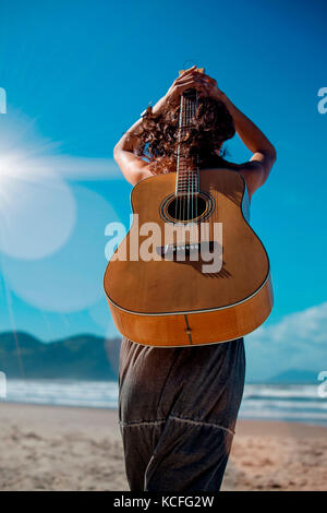 Person woman guitar back Stock Photo Alamy