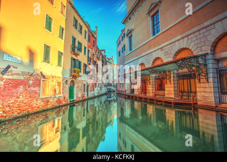 Historical streets in water canal filled with green water. Famous old town Venice, Italy. Stock Photo