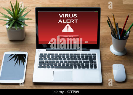 Laptop Infected By Virus With Cleaning Option At Desk Stock Photo
