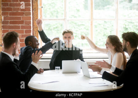 Mae and female multiethnic coworkers ready to give each other fist bump, celebrating great idea about business project. Colleagues in meeting, collabo Stock Photo