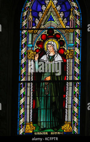 Stained Glass in the Church of Sant Agostino (St Augustine), one of the oldest churches of San Gimignano, Tuscany, Italy, depicting Saint Rita Stock Photo