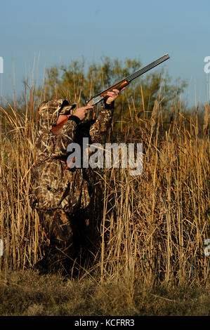 a-duck-hunter-aiming-and-