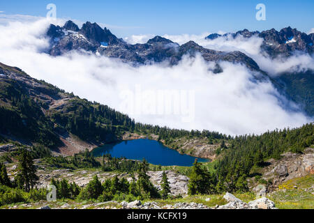 View of Cobalt Lake and Triple Peak on route to summit of 5040 Peak in the Alberni-Clayoquot region on Vancouver Island, BC, Canada. Stock Photo