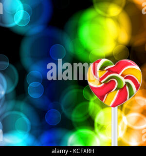 Colorful spiral lollipop on abstract glowing circles background Stock Photo