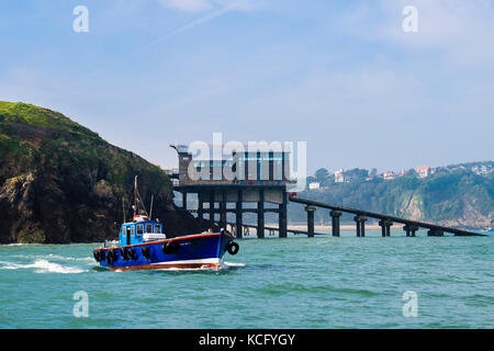 Caldey Island boat at sea passing the new Lifeboat Station below Castle Hill cliffs. Tenby, Carmarthen Bay, Pembrokeshire, Wales, UK, Britain Stock Photo