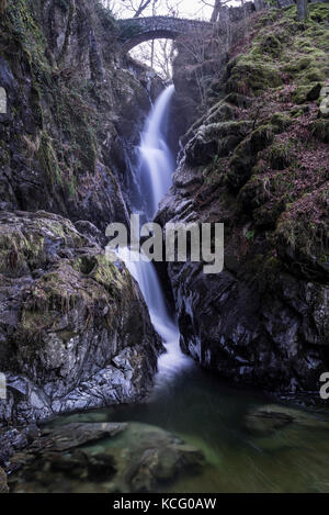 Aira Force waterfall and bridge in Winter, near Ullswater, Lake District, Cumbria, England, UK Stock Photo