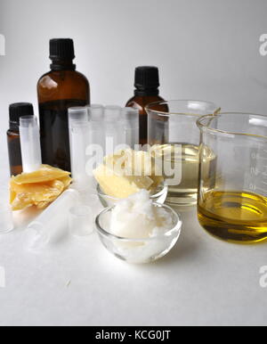 Ingredients and tools for making natural cosmetic products, skin care and beauty creams. Glass bottles, lip balm tubes, oils and laboratory glass Stock Photo