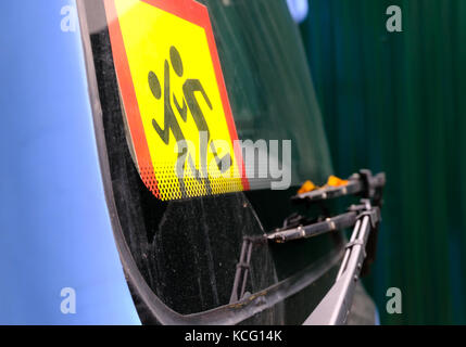 Sign 'Beware of children!' on the windshield of school or sightseeing bus. Safety when transporting schoolchildren. Stock Photo