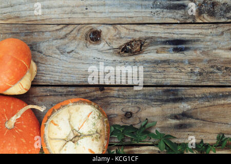 Autumnal background with pumpkins on old wooden table Stock Photo