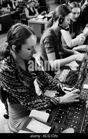 Telephone exchange call centre London Uk female young women office work woking shifts at a switchboard 1970s UK HOMER SYKES Stock Photo