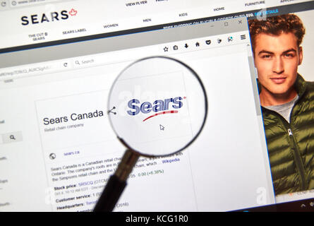 MONTREAL, CANADA - OCTOBER 2, 2017: Sears Canada web page under magnifying glass. Sears Canada is a Canadian retail chain headquartered in Toronto, On Stock Photo