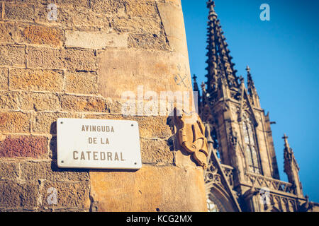 marble street sign where it is written in Spanish - Avenue of the cathedral - and in background, cathedral of barcelona, spain Stock Photo