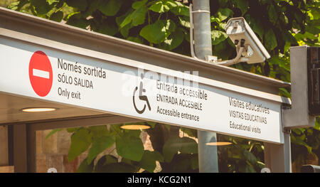 sign indicating in Catalan, Spanish and English - only exit, accessible entrance, educational visits Stock Photo