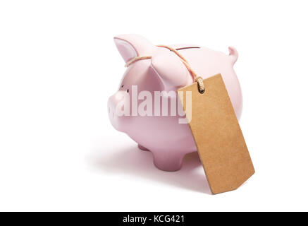 Piggy bank with blank tag tied with string. Stock Photo