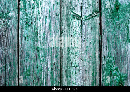 Cracked weathered emerald green shabby chic painted wooden board texture, front view Stock Photo