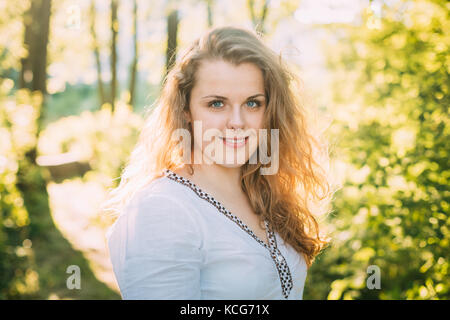 Close Up Portrait Of Happy Young Beautiful Pretty Plus Size Caucasian Girl Woman Dressed In White Blouse And Enjoying Life, Smiling, Having Fun In Sum Stock Photo