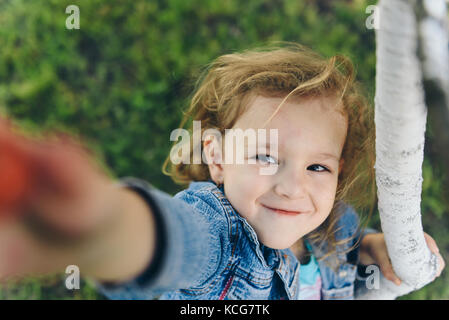 Happy little girl picking cherry in garden Stock Photo