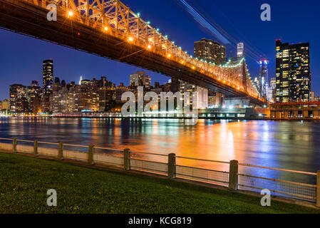 Evening view of Manhattan Midtown East from Roosevelt Island with the Queensboro Bridge. New York City Stock Photo