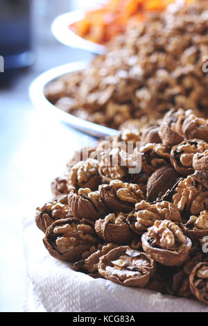 Chopped walnuts and dried fruits in bags at east bazar Stock Photo