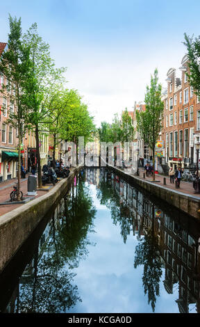 Amsterdam, Netherlands - July 13, 2017:  Pedestrians walking in Amsterdam, known for its artistic heritage, numerous canal system and narrow houses wi Stock Photo