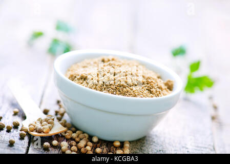 coriander in bowl and on a table Stock Photo