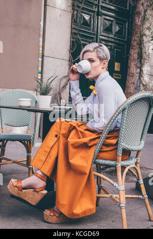 Young woman at a coffee house, Madrid, ES Stock Photo