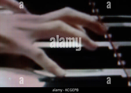 Woman hand playing piano close-up- Stock Photo