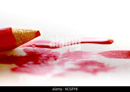 Red Pencil painting red lines on a white papper, concept Stock Photo