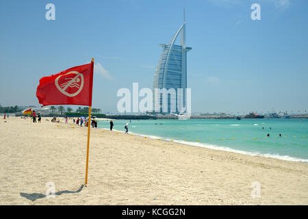 No swimming sign on Jumeirah beach, next to Burj-Al-Arab in Dubai, United Arab Emirates