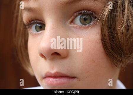 Portrait of a curious yet scared little girl Stock Photo