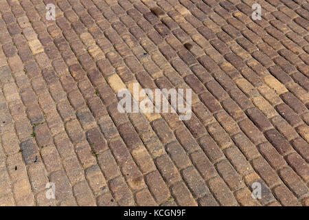 Made of cobblestone road for pedestrians. Photo close-up. Background of stone materials Stock Photo